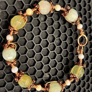Jade and copper wire work bracelet with hook closure.